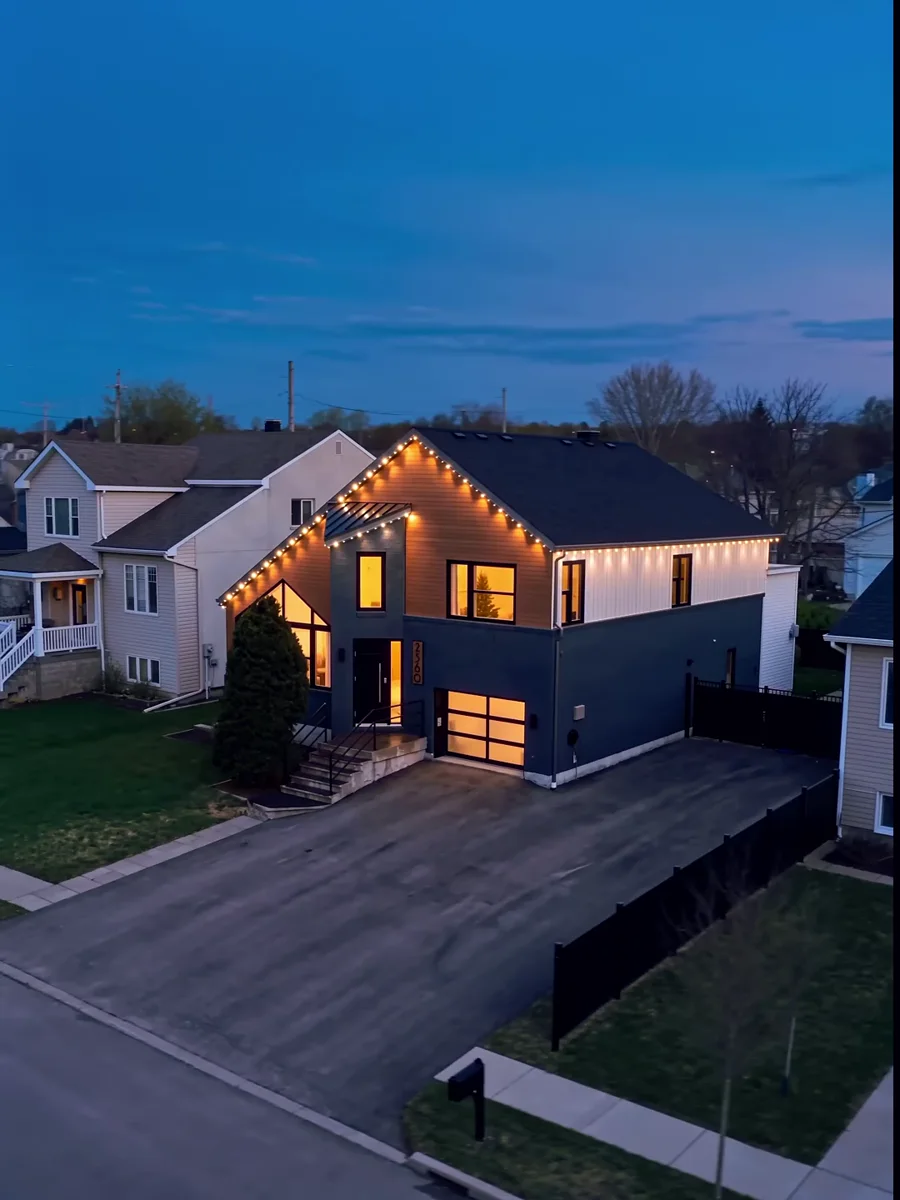 Real Vision Bleu home at dusk with warm-white permanent LED roofline lighting